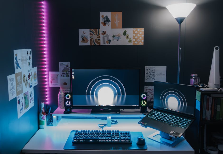 Stylish gaming setup featuring dual monitors, LED lighting, and tech accessories for an immersive experience.